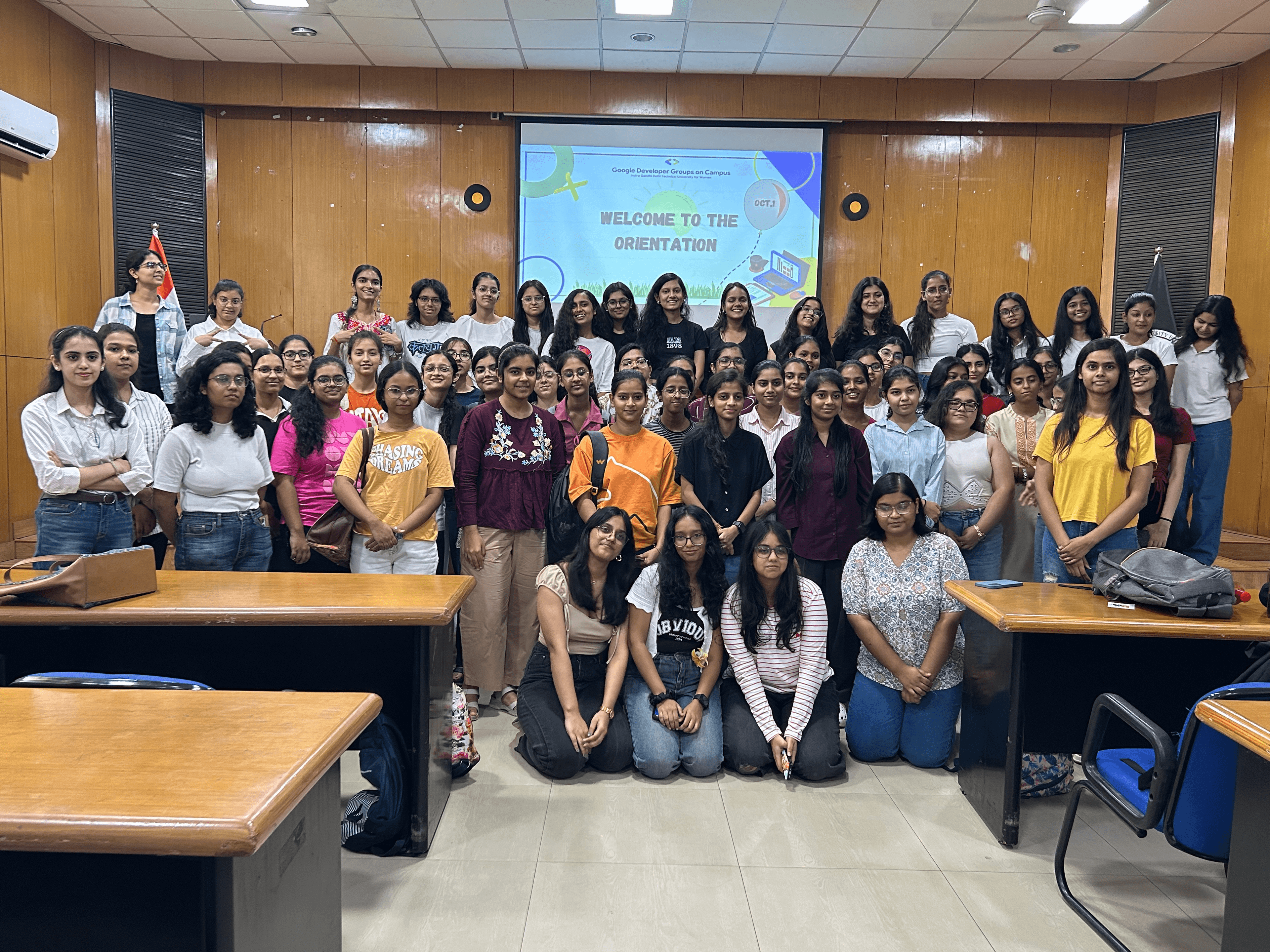 A group of diverse people collaborating around a table with laptops.